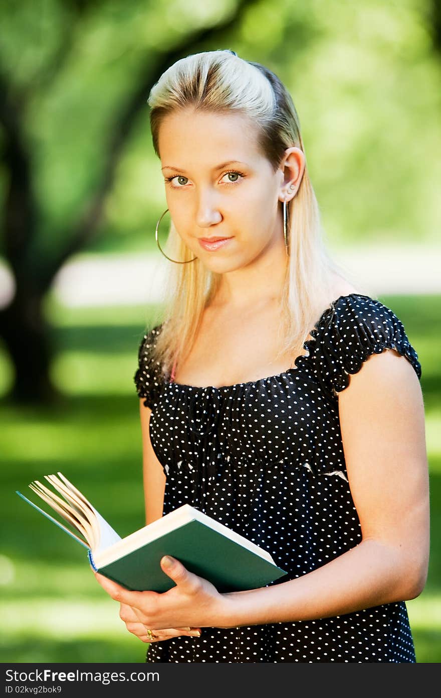 Girl with book in park