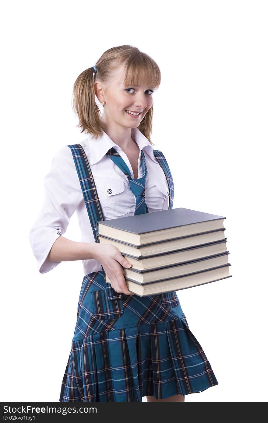 Senior high school student in uniform holding the stack of book. A young and beautiful schoolgirl is wearing a traditional uniform with textbooks. Senior high school student in uniform holding the stack of book. A young and beautiful schoolgirl is wearing a traditional uniform with textbooks.