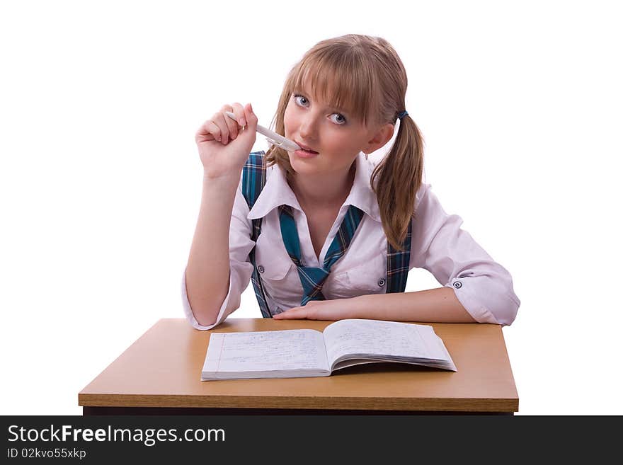 Portrait of a sweet little girl at her classroom, writing an exam. A happy schoolgirl doing her homework. Young student writing.