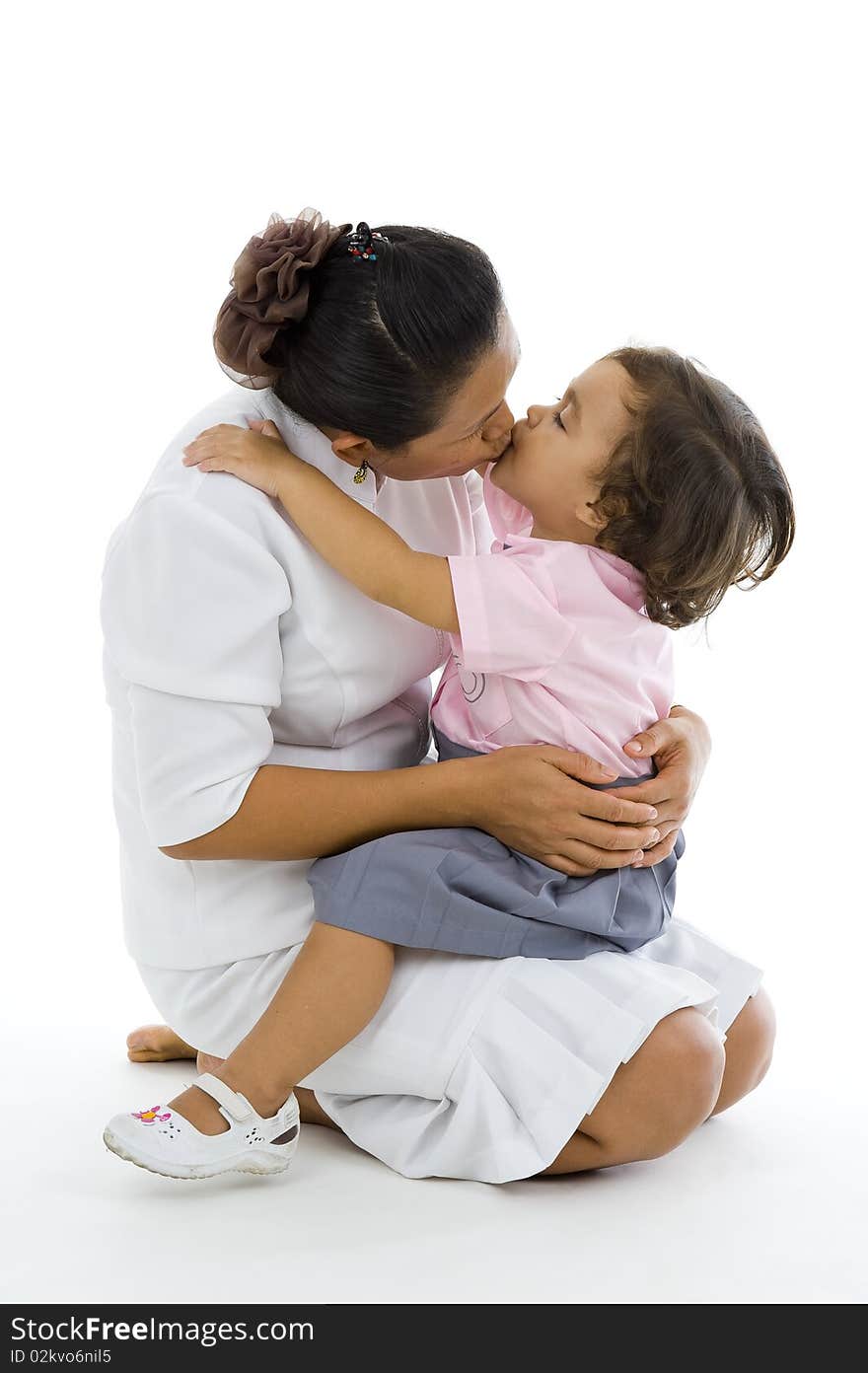 Daughter and mother kissing, isolated on white background