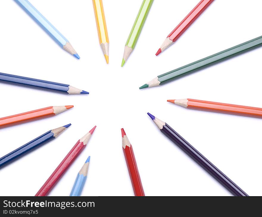 Several color pencils pointing at the same empty spot. Several color pencils pointing at the same empty spot.