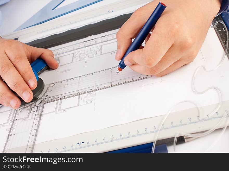 Architect working on architectural plans in the office