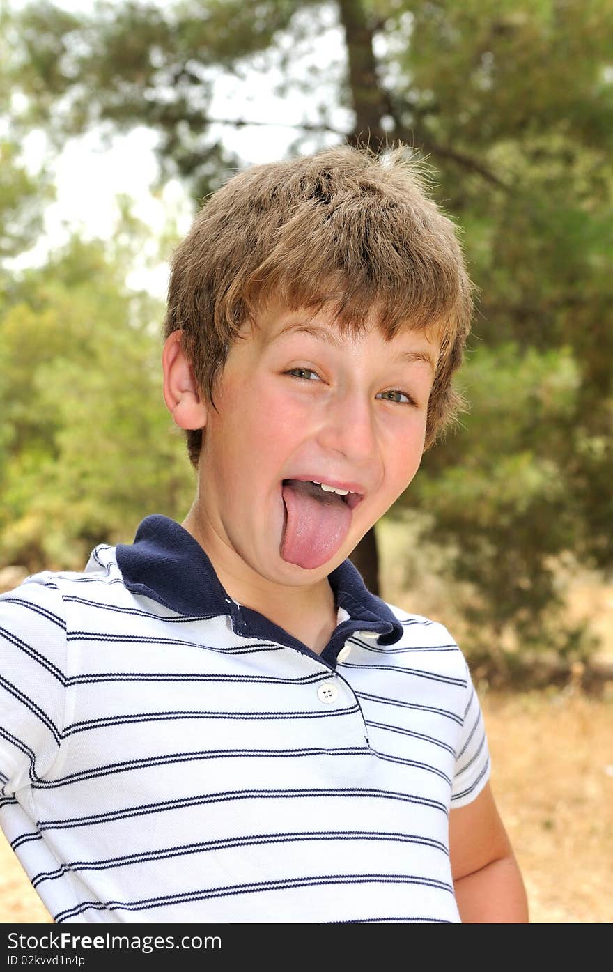 A boy in a forest glade make faces photographer. A boy in a forest glade make faces photographer