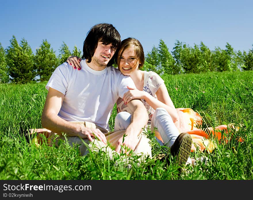 Beautiful girl with smile and boy on grass. Beautiful girl with smile and boy on grass