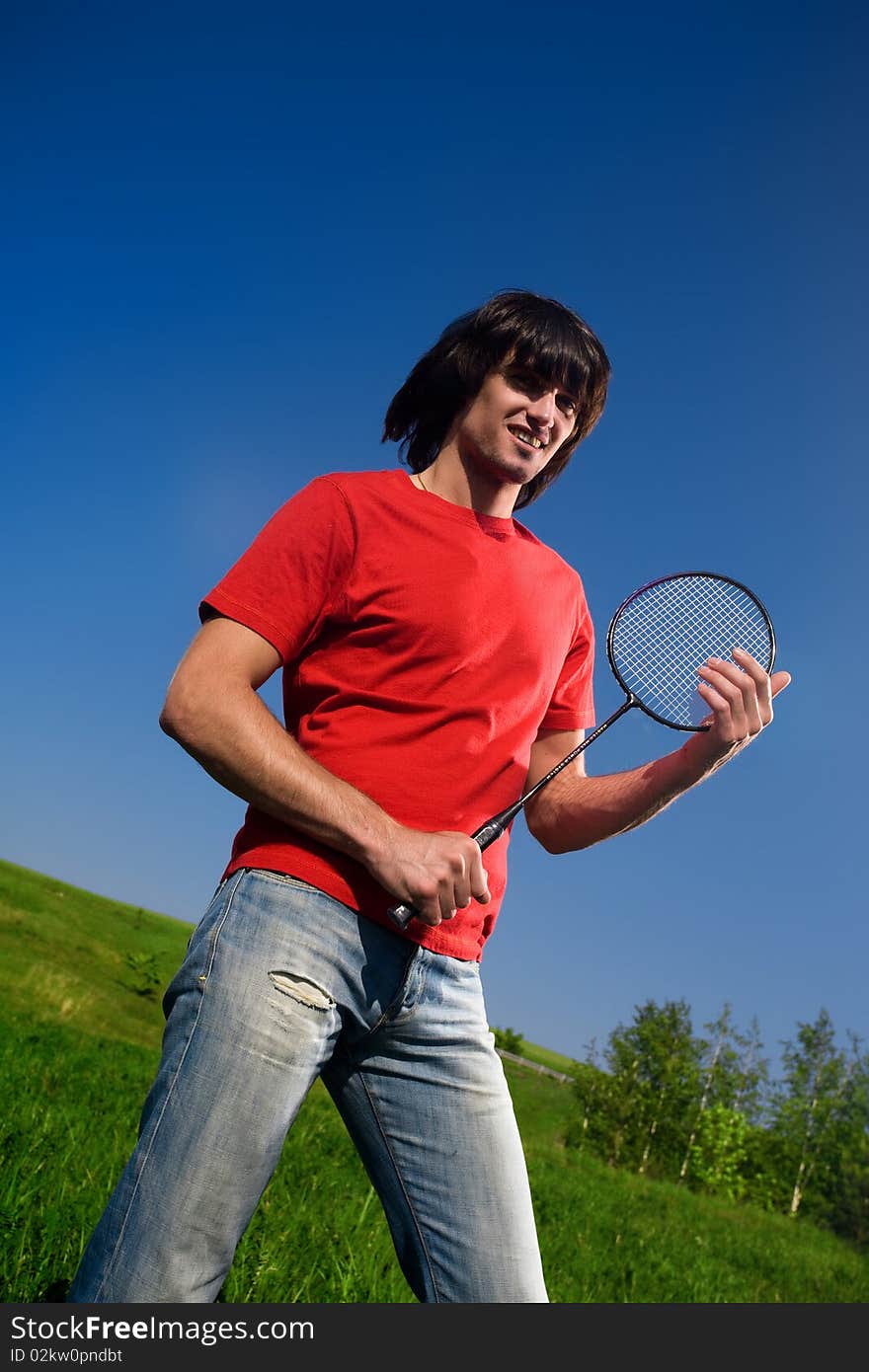 Boy in red t-shirt with racket