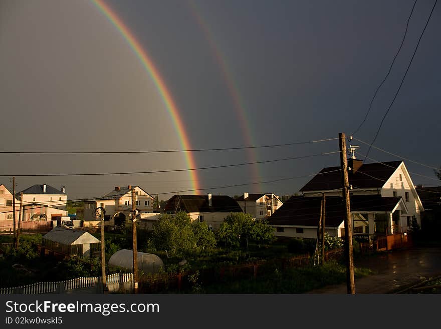 This is a rainbow on the background of houses