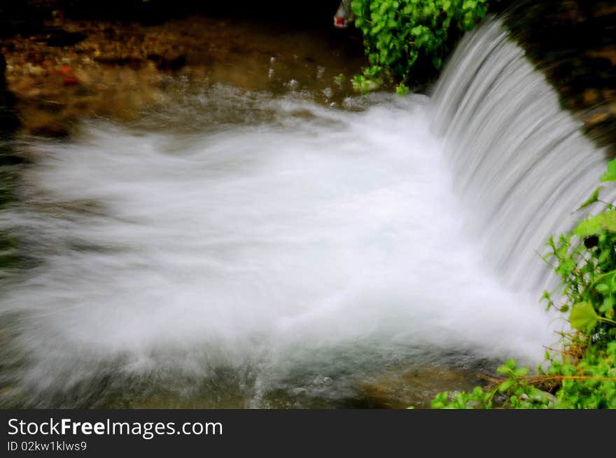 A waterfall in the path of a mountain river