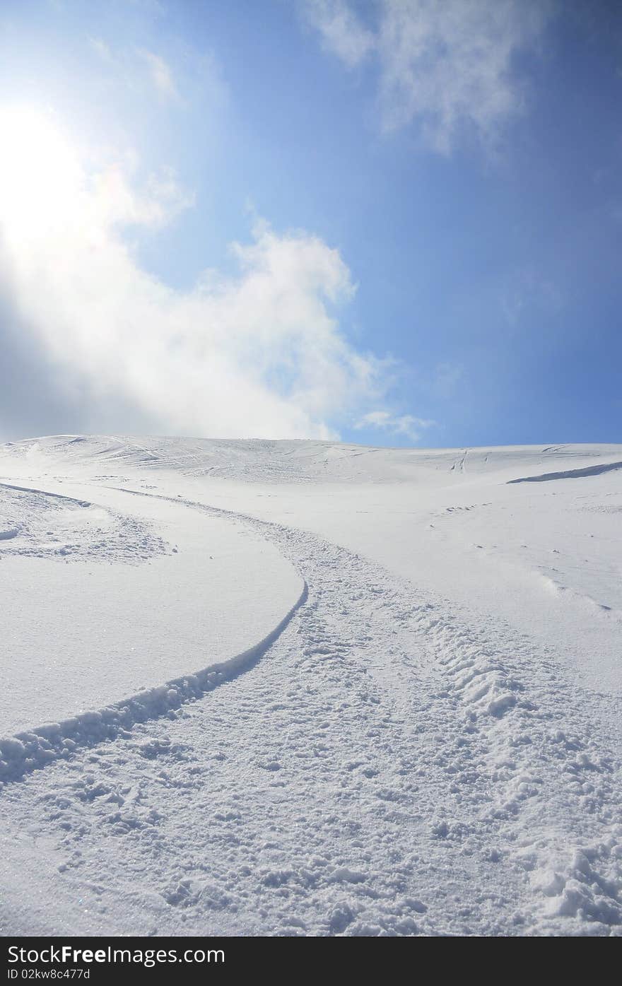 Snow tracks on virgin white snow of the slope. Snow tracks on virgin white snow of the slope