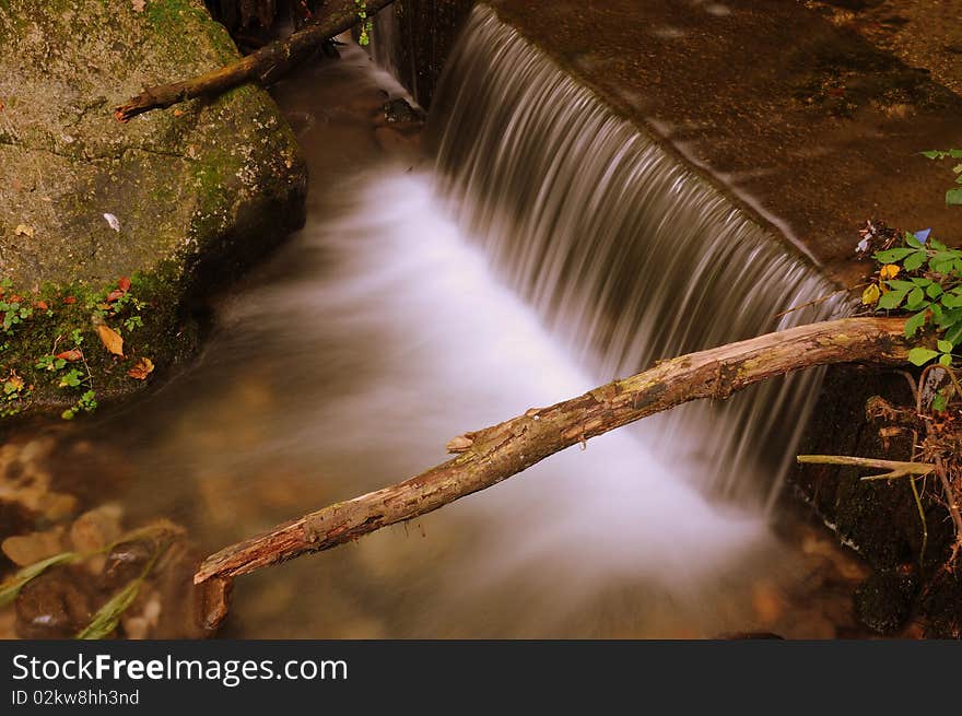 A waterfall in the path of a mountain river