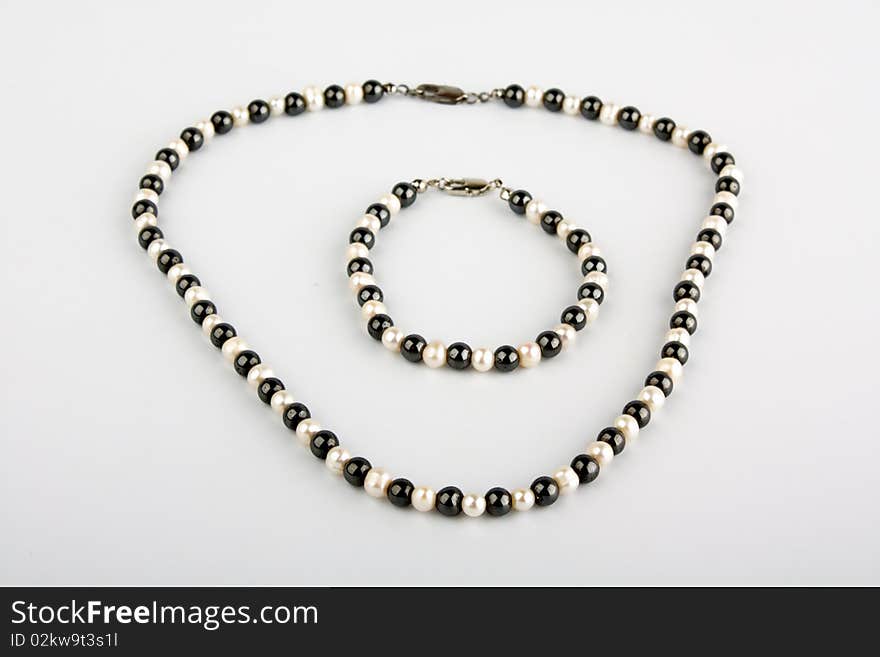 White pearls and black stone beads on a thread. White pearls and black stone beads on a thread