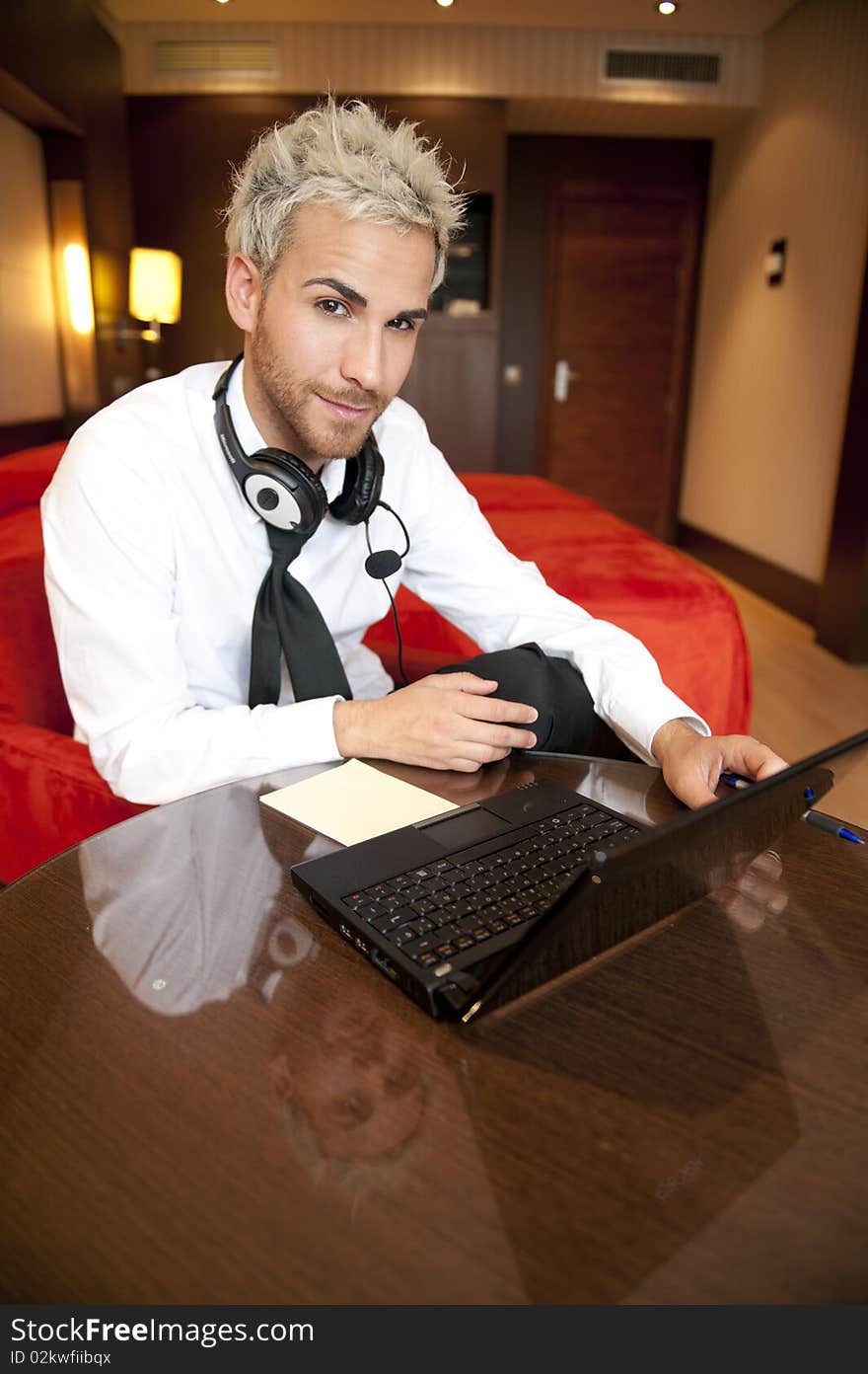 Man in headphones at work place with misterious expression