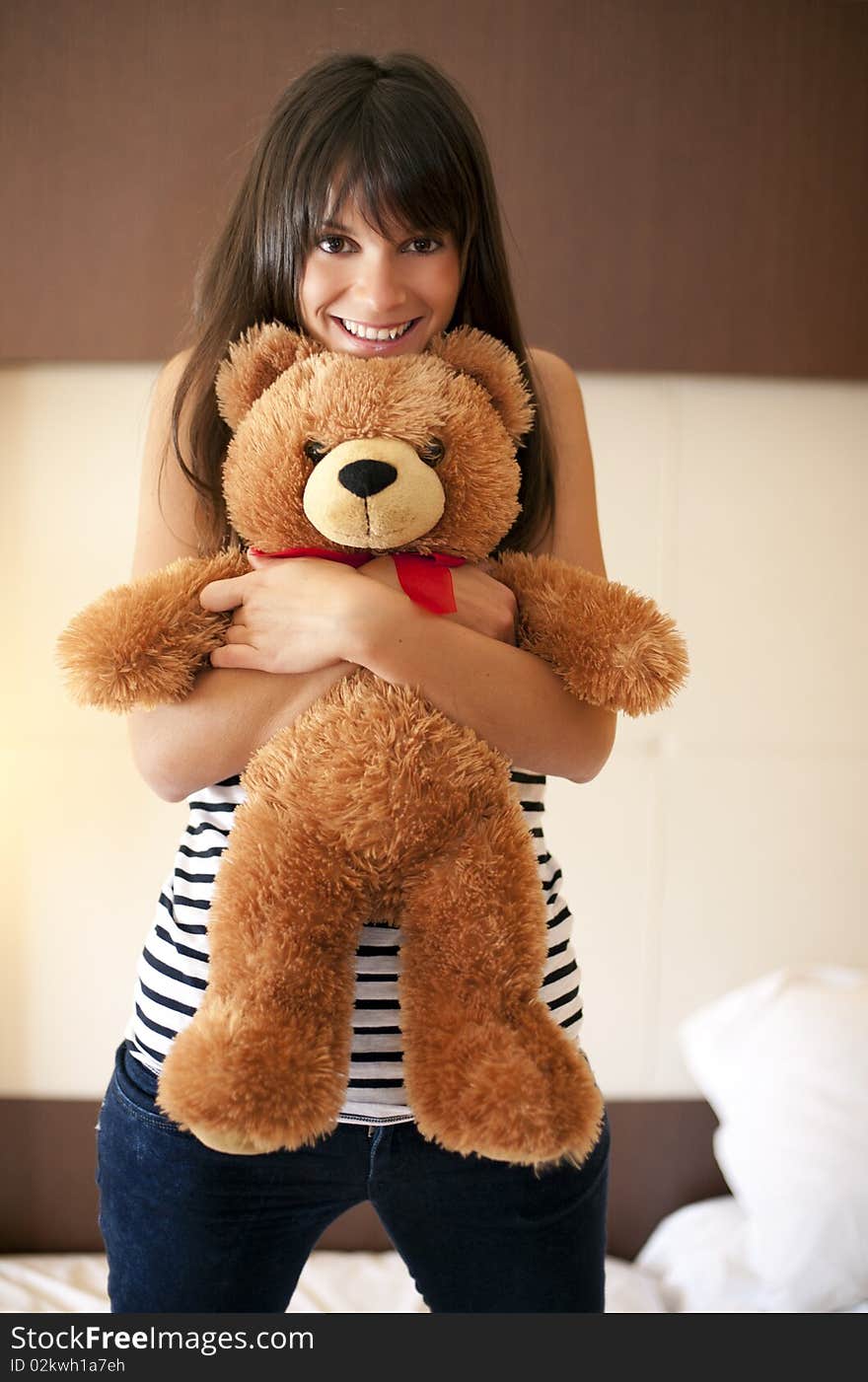 Young woman with teddy bear in bed. Young woman with teddy bear in bed