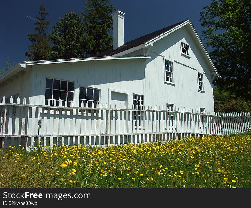 White house and fence with flowers. White house and fence with flowers