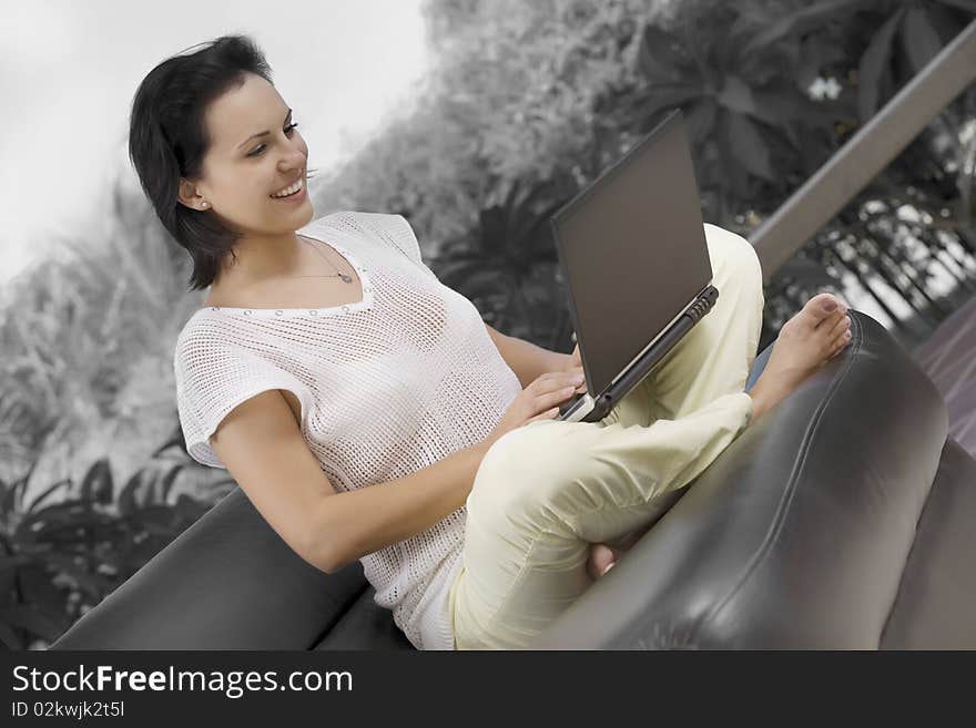 Portrait of woman with laptopm in summer environment