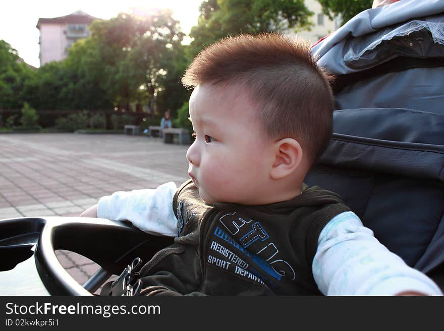 Lovely Chinese baby is sitting under sunshine. Lovely Chinese baby is sitting under sunshine