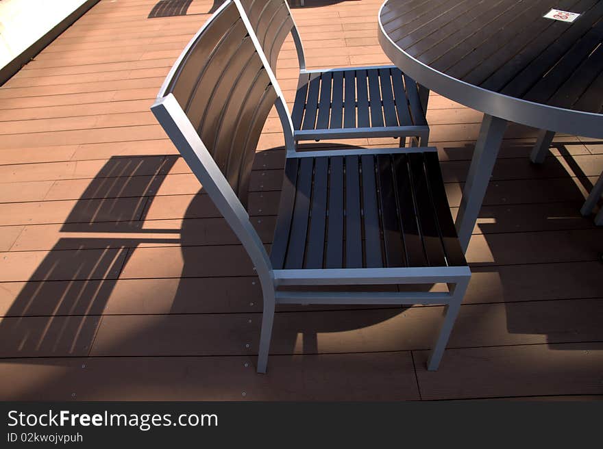 Lounge chairs at sunset on a resorts  deck .