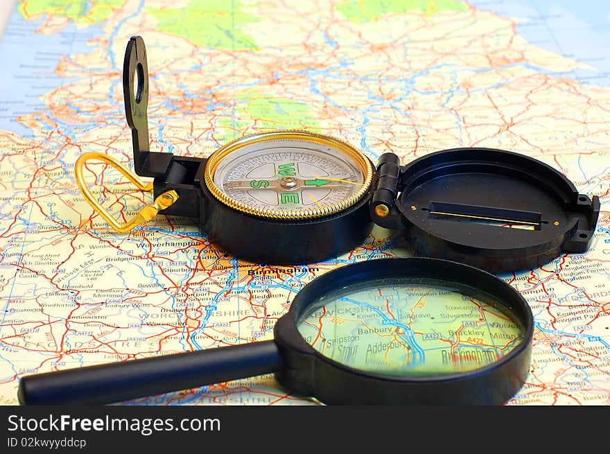 Compass and magnifier on a map for travel by close up. Compass and magnifier on a map for travel by close up