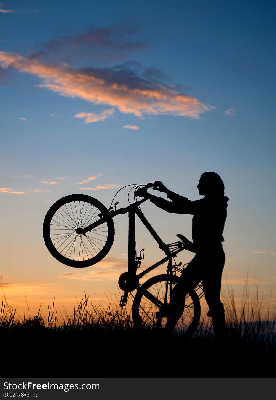 Biker silhouette against the sunset. Biker silhouette against the sunset