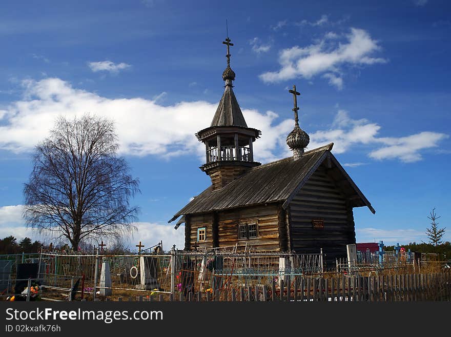 The old wooden church on rustic graveyard. The Chapel Ilii, village Pyalima, Kareliya. 18 age. Russian north