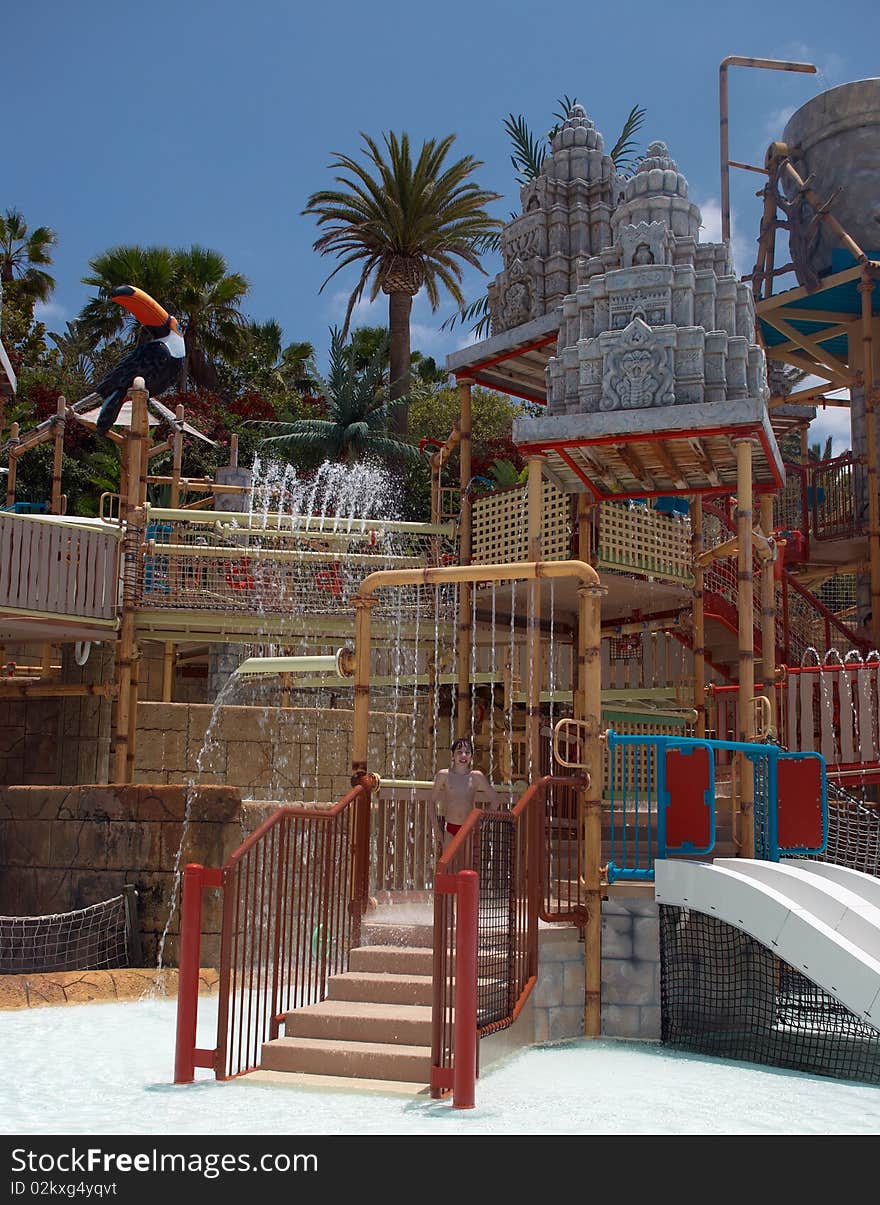 Young boy in a playground of the waterpark. Spain, Tenerife. Young boy in a playground of the waterpark. Spain, Tenerife