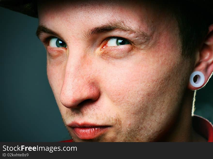 Close-up of a young man in hat