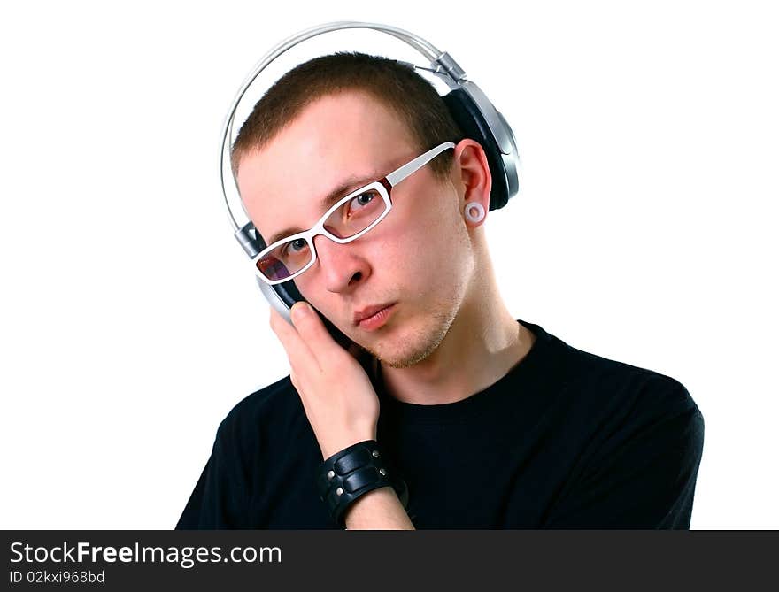 Young man listening to music. Studio shot.