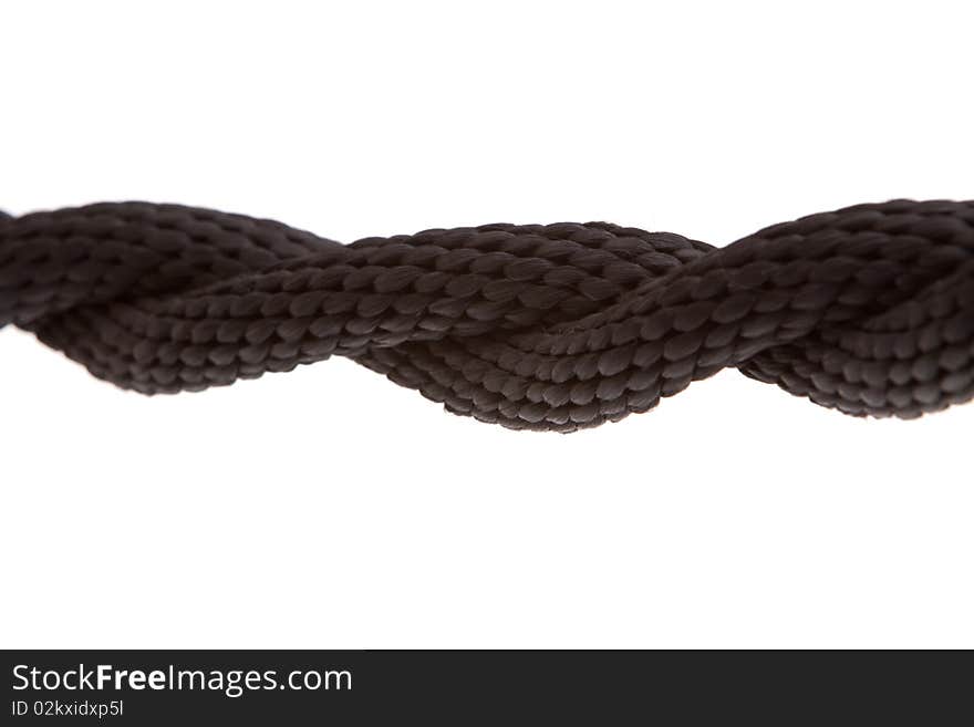 Twisted black rope on white background