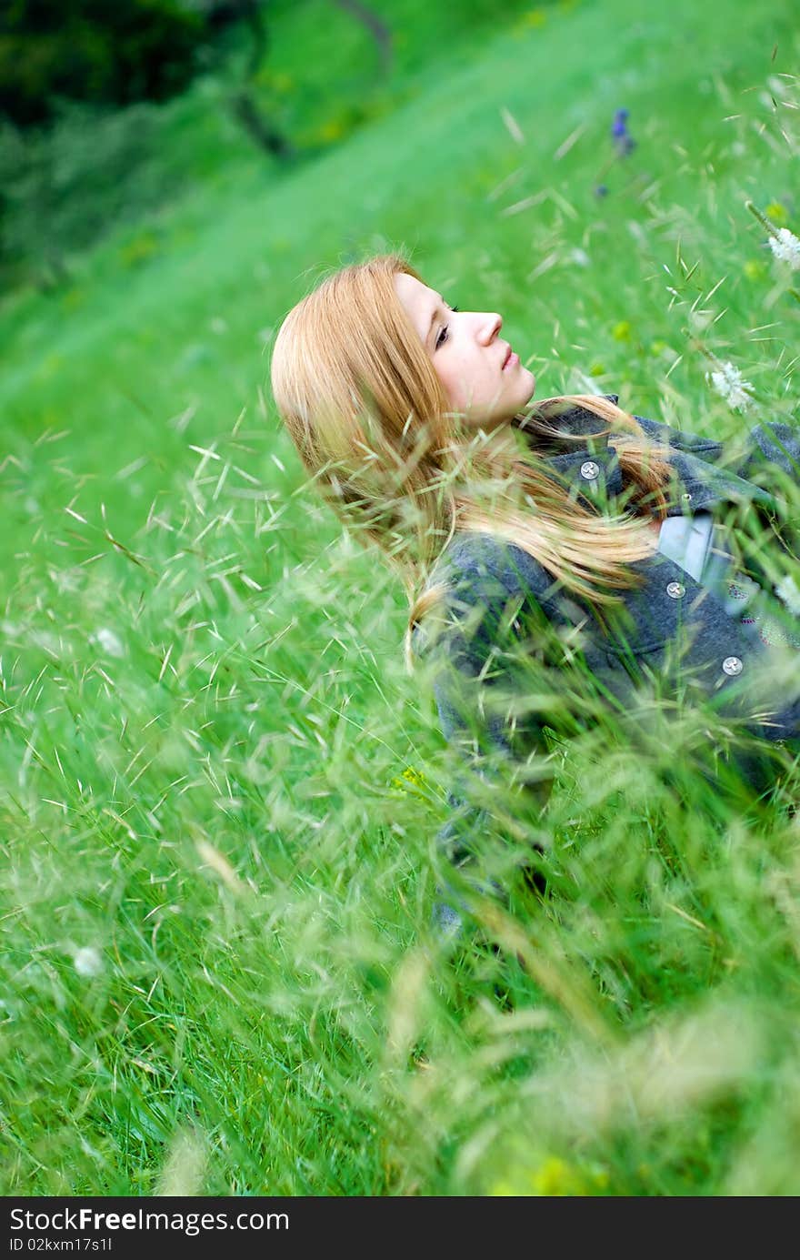 Beautiful teen blond girl staying in the meadow. Beautiful teen blond girl staying in the meadow