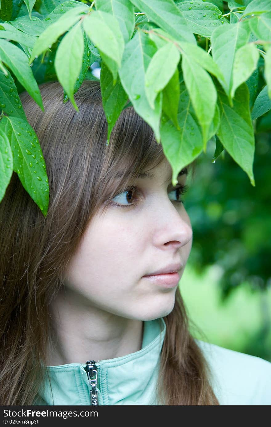 Young woman under the leaves