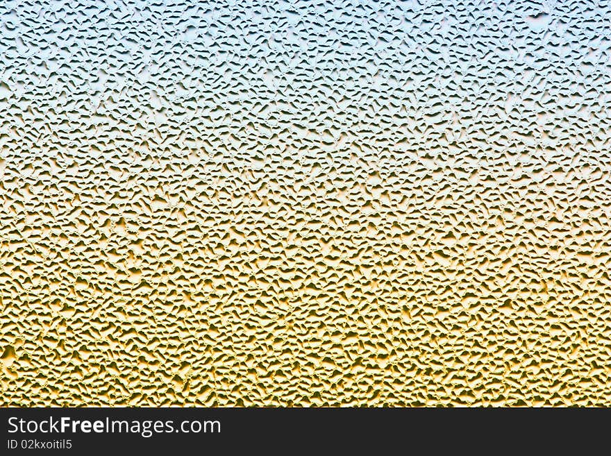 Water drops on metalized car paint, hence the tiny grain-looking dots on the surface