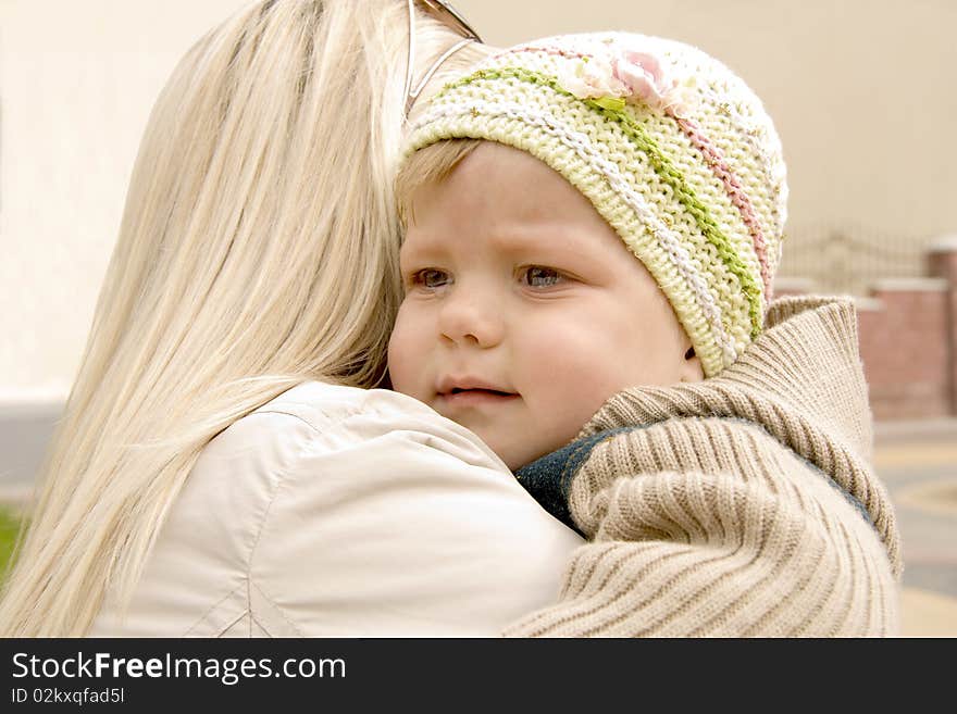 Mum embraces and calms the tear-stained child. Mum embraces and calms the tear-stained child