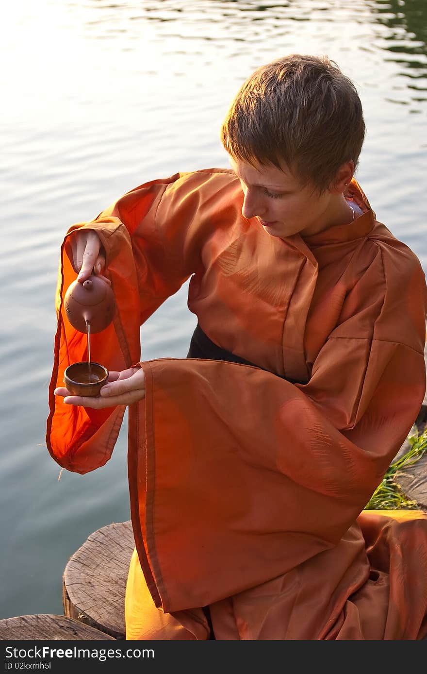 Tea ceremony master serving tea near the water