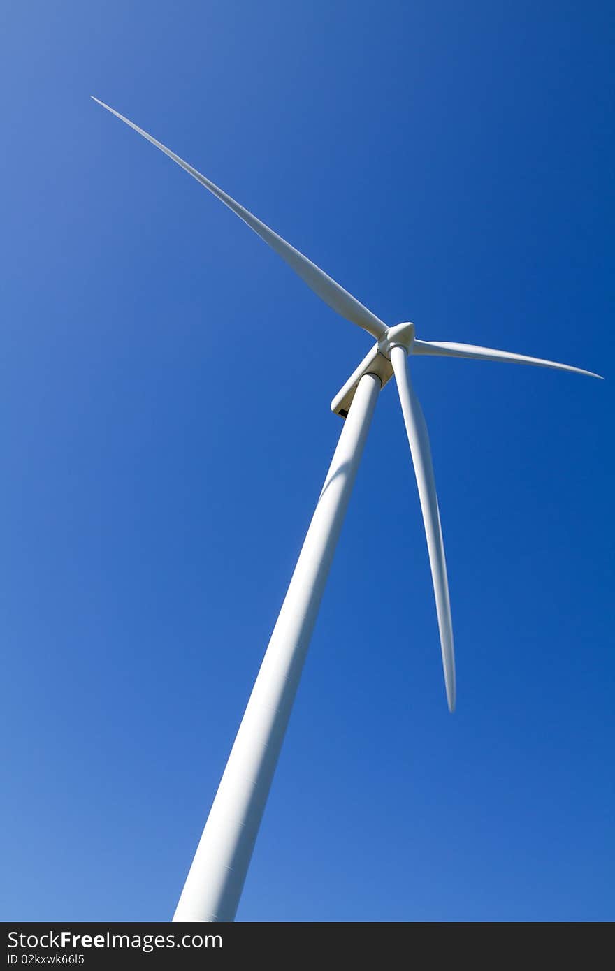 Wind turbine on blue sky