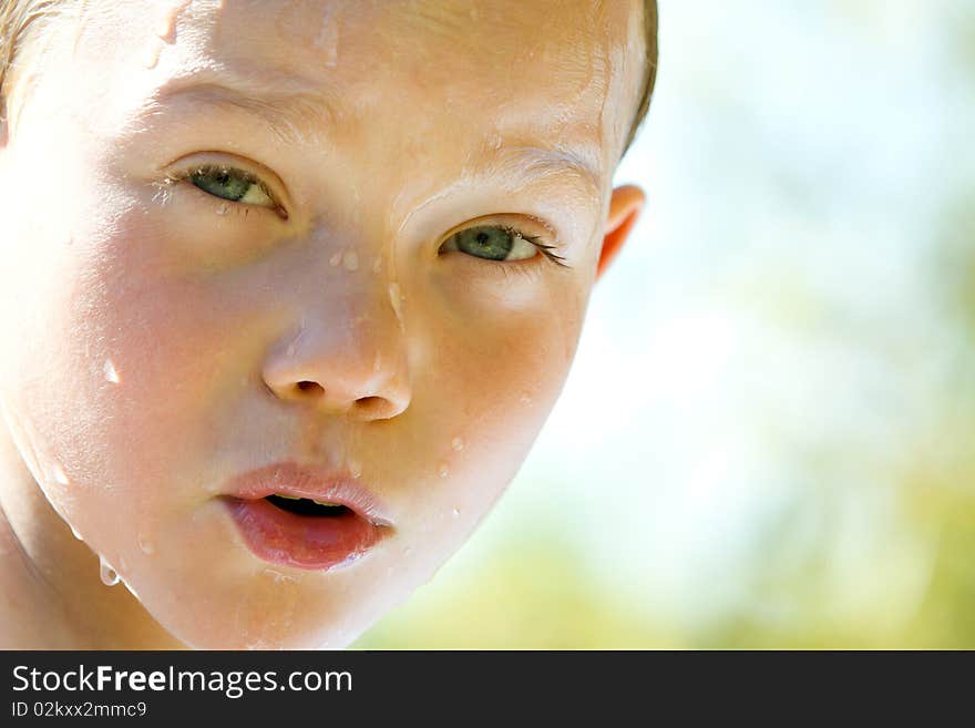 Portrait of a young child with water drop on face