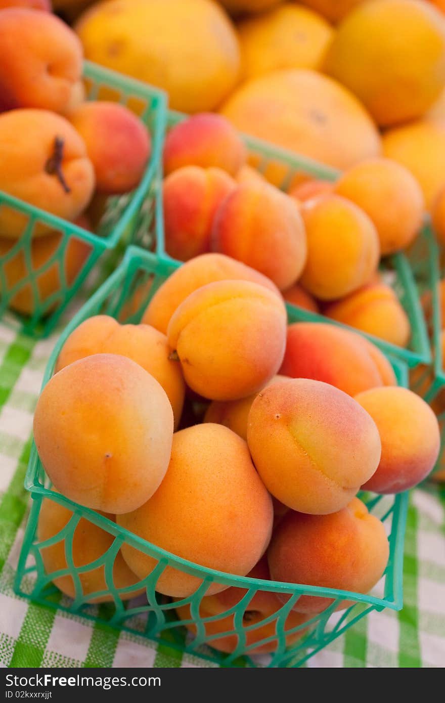 Bunches of ripe organic apricots at the local farmers market