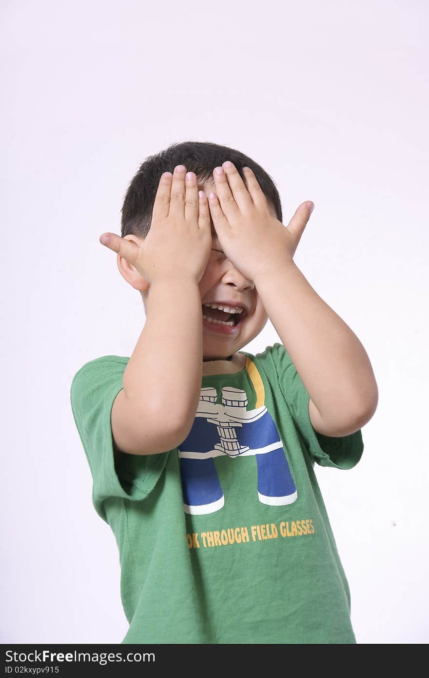 Laughing boy covering face with hands