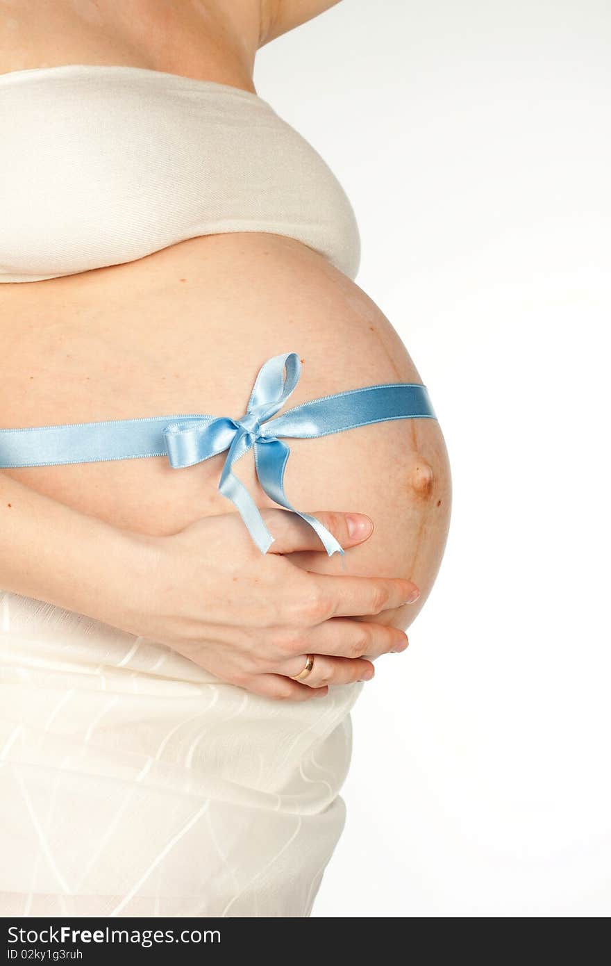 Pregnant girl with a blue ribbon tied on the stomach