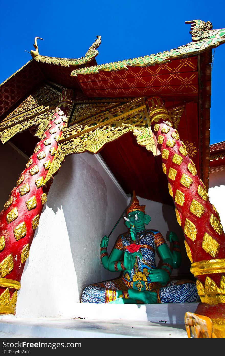 Green devil protector sitting at the front gate of Doi Suthep temple, Thailand