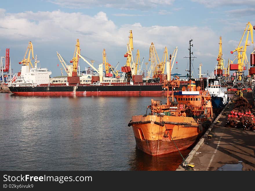 View of trading port with cargo ships and cranes