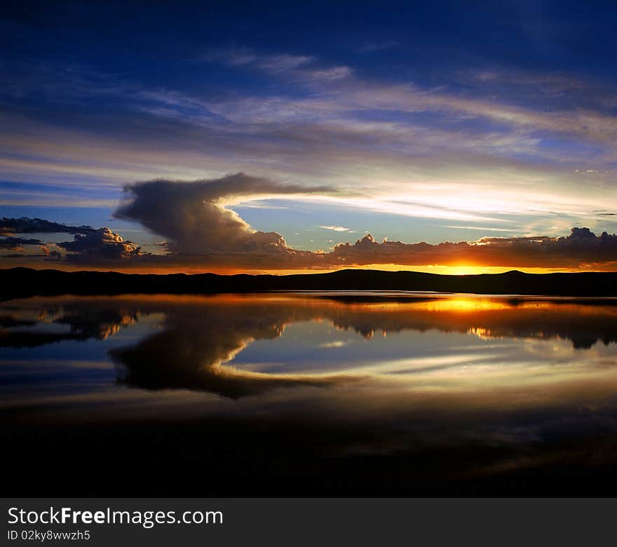 Cloudscape at sunrise. Ray pierces through the thick clouds. Cloudscape at sunrise. Ray pierces through the thick clouds.