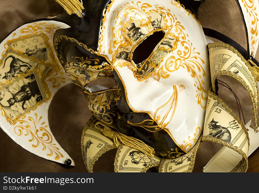 Photo of a venice carneval mask putted on a wood table. Photo of a venice carneval mask putted on a wood table