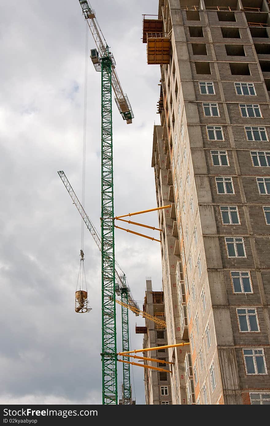 New realty constraction - crane lifting liquid concrete. New realty constraction - crane lifting liquid concrete