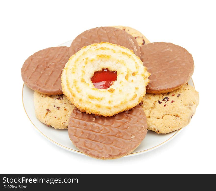 Fruit and jam cookies with chocolate biscuits on a plate. Isolated over white background. Fruit and jam cookies with chocolate biscuits on a plate. Isolated over white background.