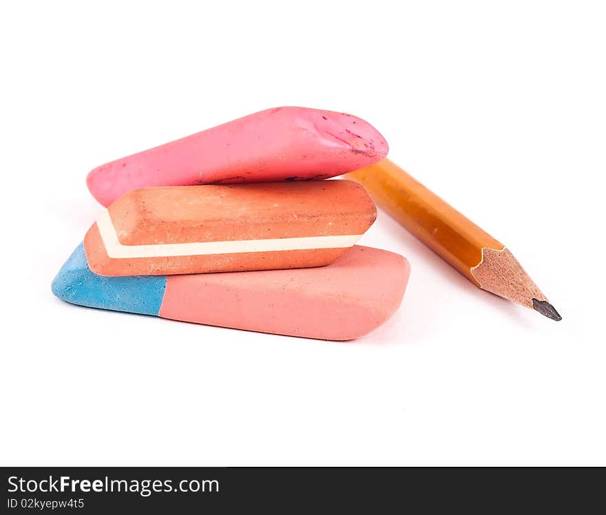Erasers and pencil on white