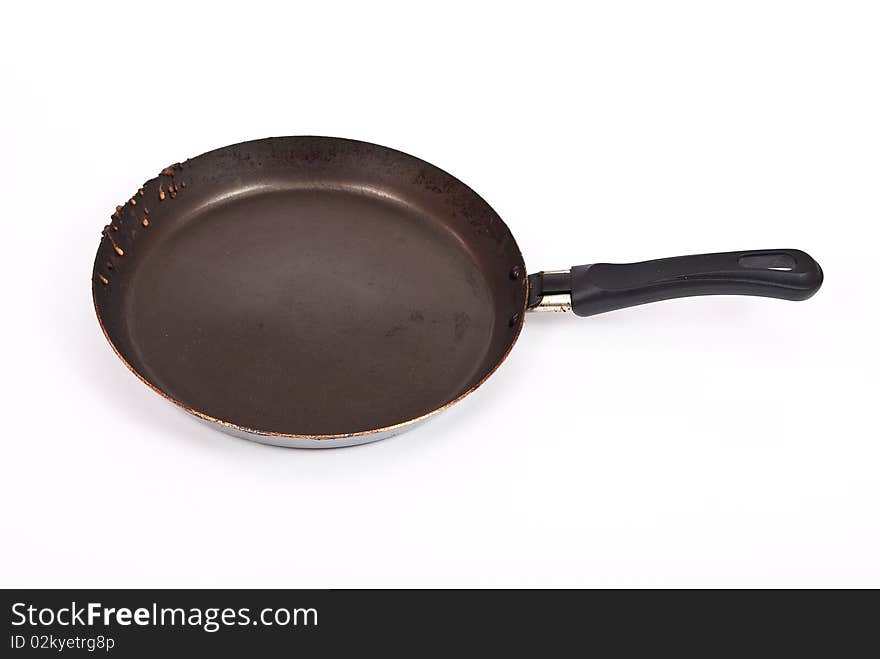 Empty frying pan isolated over white