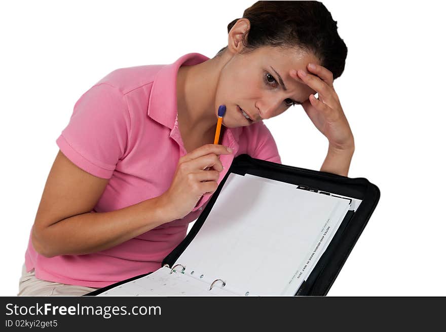 Woman looking concerned over her planner. Woman looking concerned over her planner