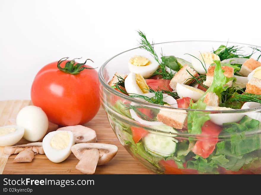 Fresh raw vegetable salad in glass bowl