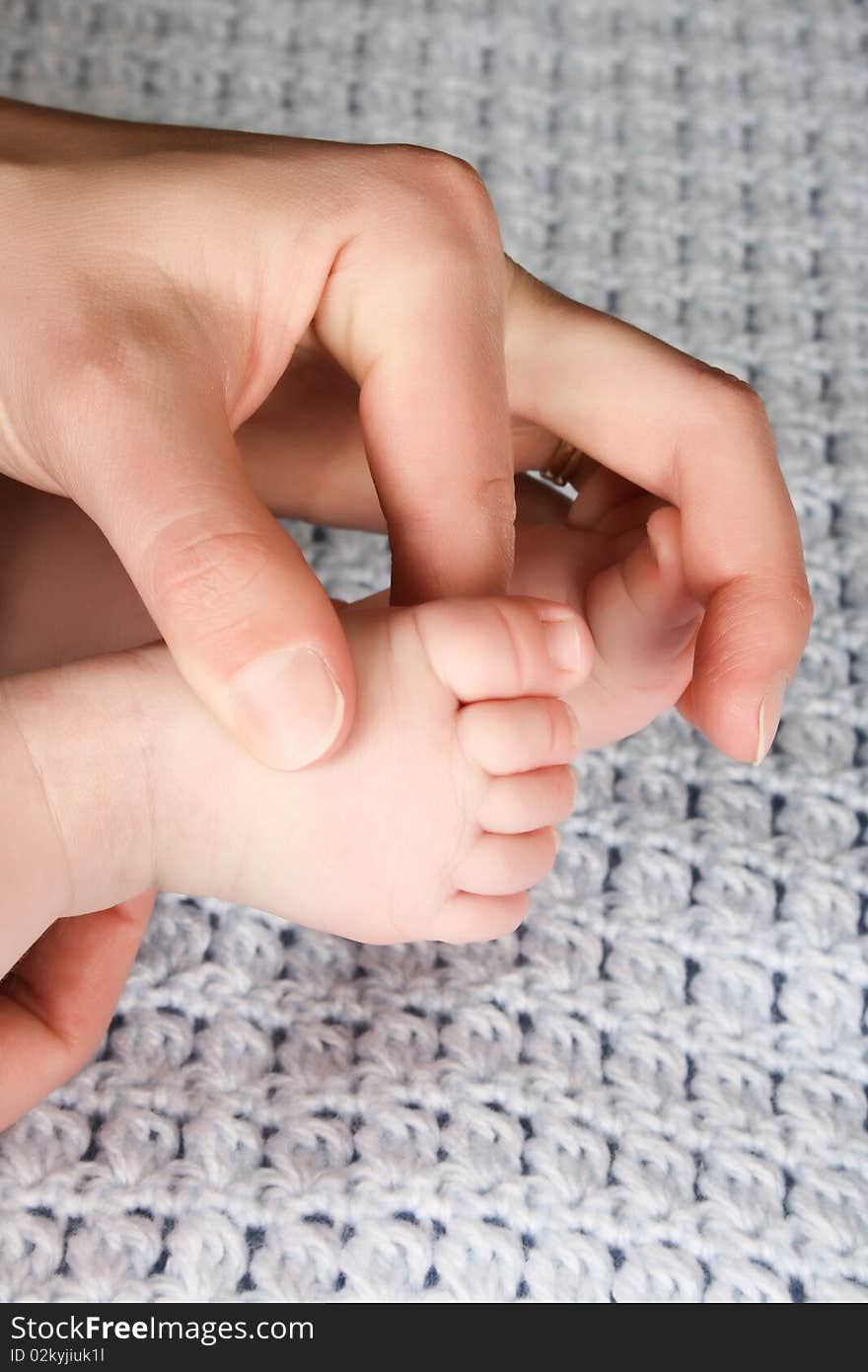 Hands and feet of caucasian mother and baby