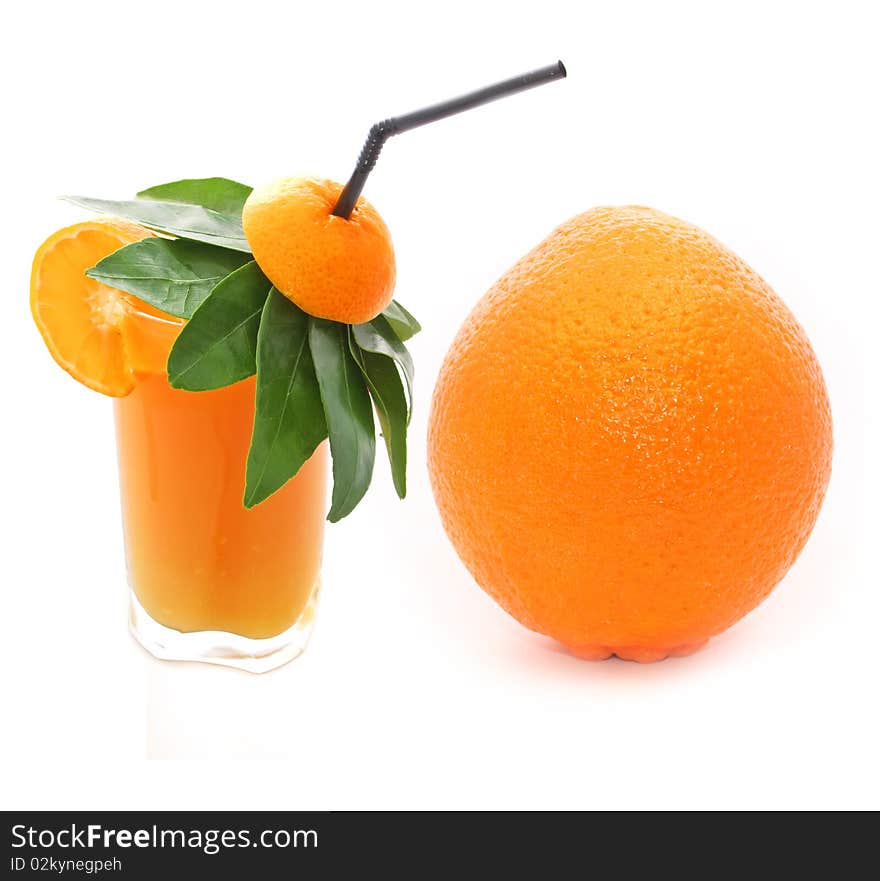 A glass of orange juice and a large orange isolated on a white background. A glass of orange juice and a large orange isolated on a white background