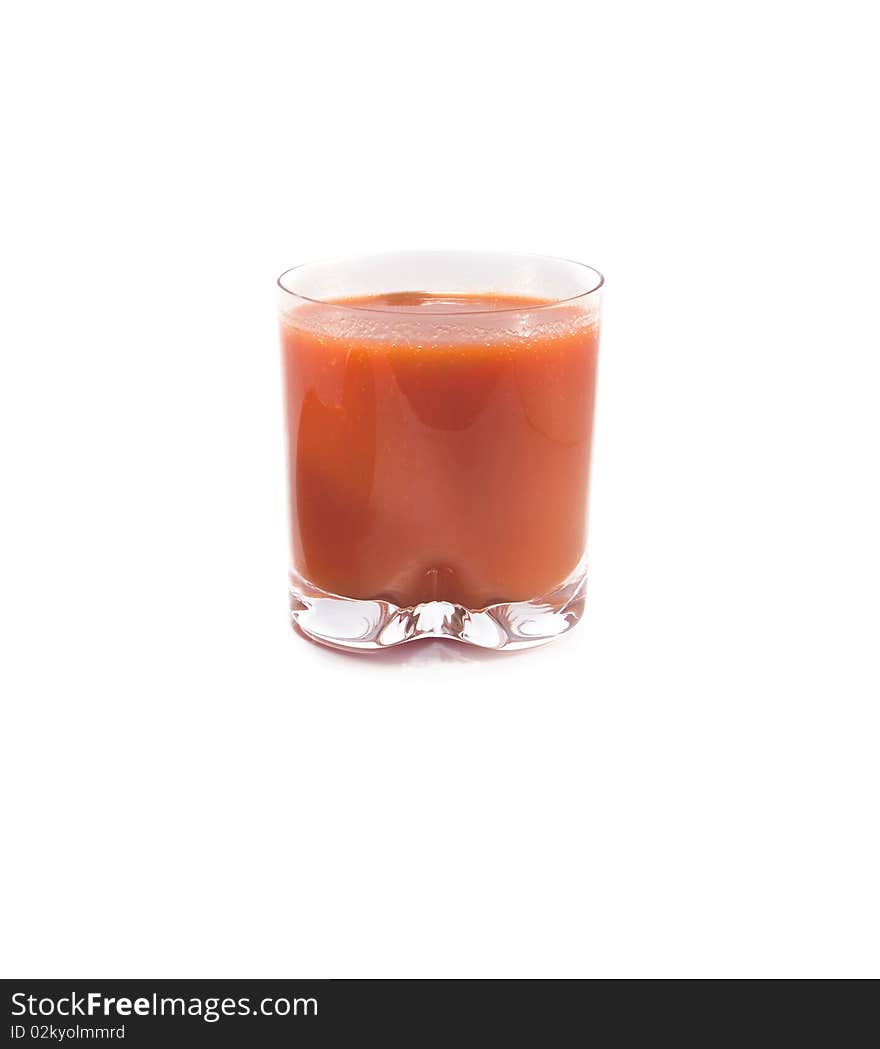 Glass of tomato juice is isolated on a white background